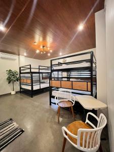 a room with two bunk beds and a table and chairs at Navia in Sañgitan +47 photos