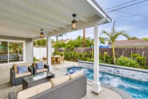 an outdoor patio with a pool and a table and chairs at Gorgeous Upgraded 5 Bedroom & 4 Bath Home with Jacuzzi in Orange