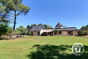 a house with a large yard with a tree at La grande maison in Orgères