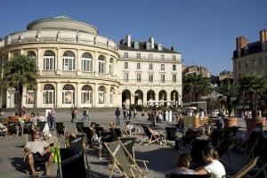a group of people sitting in chairs in front of a building at Le moulin de la chicane in Orgères +6 photos