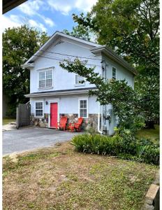 a white house with a red door and chairs at Red Bank Cozy Nest in Chattanooga +13 photos