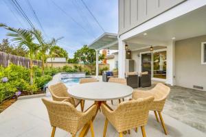 a patio with a white table and chairs at Gorgeous Upgraded 5 Bedroom & 4 Bath Home with Jacuzzi in Orange
