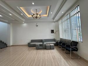 a living room with a couch and chairs and a chandelier at Chakra Rauniyar in Kathmandu