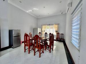 a kitchen with a table and chairs and a refrigerator at Chakra Rauniyar in Kathmandu