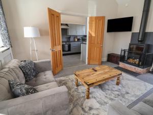 a living room with a couch and a coffee table at Elwy Cottage in St Asaph