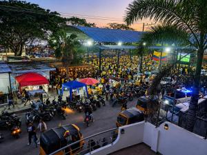 a crowd of people on a city street at night at Departamento frente a la playa in Playas