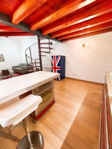a kitchen with wooden ceilings and a staircase in a room at al home in Crema