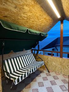 a bench on a porch with a view of the ocean at BelGa Guest House in Gyumri