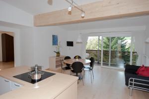 une cuisine et un salon avec une table et des chaises dans l'établissement Appartements Margit, à Vipiteno