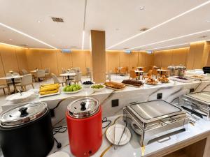 a buffet line with food on display in a restaurant at Bishkek Crystal Luxury Smart Hotel Ala-Too Square Branch in Bishkek