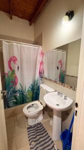 a bathroom with a toilet and a sink at Hostel Maranata in Puerto Madryn +10 photos