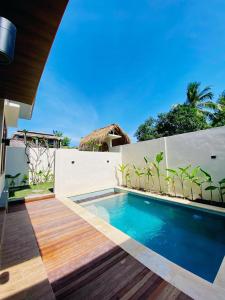 a swimming pool in front of a villa at The Res Village Lombok in Kuta Lombok