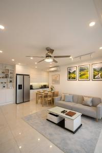 a living room with a couch and a table at Vinhomes D'capitale Hanoi Opus in Hanoi