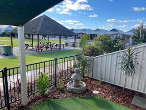 a fence with a park in the background with picnic tables at Sandpiper Escape, Unit 47 Seafront Estate in Jurien Bay