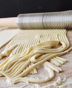 a bunch of noodles laying on a pile of flour at Hotel Vela Velo Club Vieste in Vieste