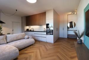 a living room with a couch and a kitchen at APARTMENT A&D Monaco in Poprad
