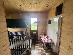 a small room with a bench and a window at Gomismta Sky House in Gomi