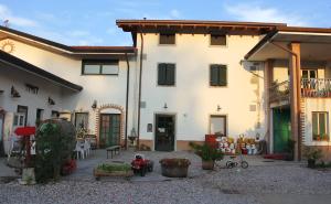 a large white building with a courtyard in front of it at Agriturismo Scribano in Prepotto