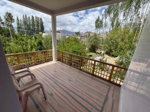 a porch with a chair and a balcony with a view at Gangs-Shun Homestay in Leh