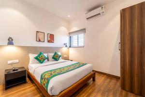 a bedroom with a large bed in a room at Treebo Premium Corner Stay in Coimbatore +27 photos