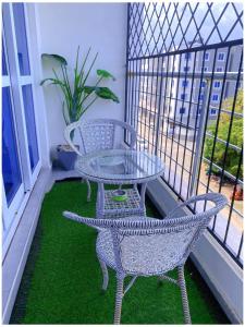 a patio with a table and chairs on a balcony at Nyali Glam Apartment in Mombasa