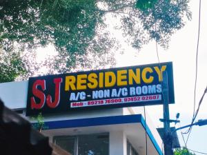 a sign for a restaurant on top of a building at S J RESiDENCY in Trivandrum