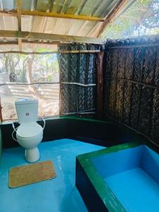 a bathroom with a toilet in a small room at Nilaveli Eco Lodge in Nilaveli