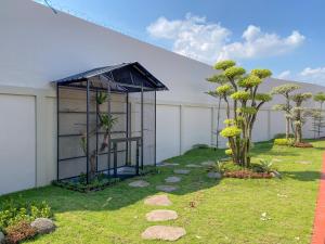 a garden with a gazebo and some trees at SANS Vibes Grand Surya Jember Mini Zoo in Panti