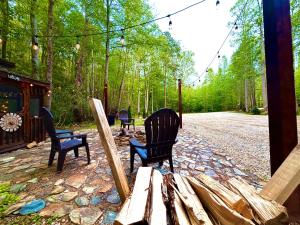 a group of chairs sitting on a patio at The Dapper Duck Log Cabin in Cosby +9 photos