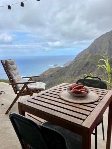 a wooden table with a bowl of fruit on it at Casa Terra Odjo N'mar in Janela +15 photos