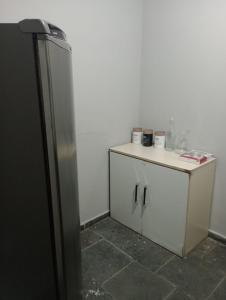 a kitchen with a refrigerator and a small counter at Rua da Expo Itaguaí in Itaguaí
