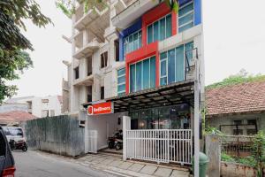 a building with a sign in front of it at RedDoorz Near MRT Bendungan Hilir in Jakarta