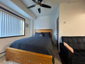 a bedroom with a bed and a ceiling fan at Anchorage Fireoved Experience in Anchorage