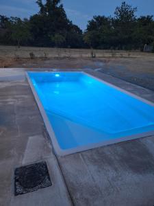 a blue swimming pool on top of a roof at le pavillon in Bonnat
