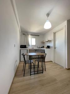 a kitchen and dining room with a table and chairs at MyLiving in Kardamaina
