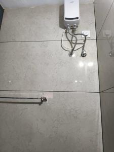 a phone sitting on top of a tile floor at S J RESiDENCY in Trivandrum