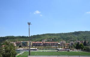 a tennis court in front of a city at Awesome Apartment In Millesimo With Wifi in Millesimo