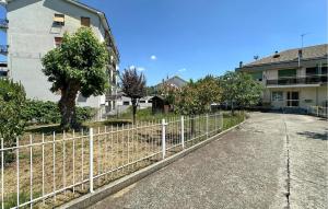 a white fence in front of a building at Awesome Apartment In Millesimo With Wifi in Millesimo +7 photos
