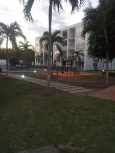 a park with a playground in front of a building at Comfortable suite-style studio apartment to rest in Flandes