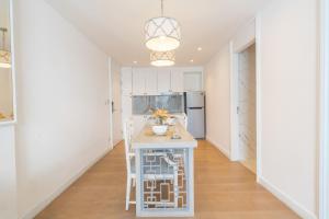 a kitchen with a white island in a room at Seavale patong phuket in Patong Beach