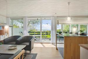 a kitchen and living room with a view of the ocean at FY273-Millinge-Buursminde-2 in Millinge