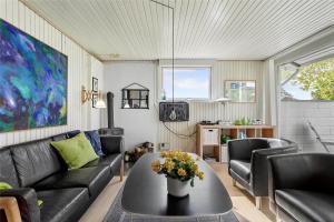 a living room with a couch and a table at FY273-Millinge-Buursminde-2 in Millinge