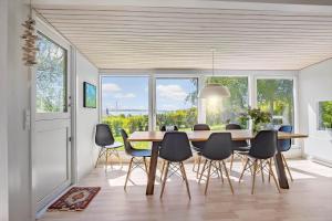 a dining room with a table and chairs and windows at FY273-Millinge-Buursminde-2 in Millinge +13 photos