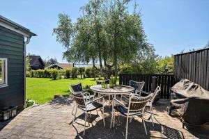 a patio with a table and chairs in a yard at FY273-Millinge-Buursminde-2 in Millinge