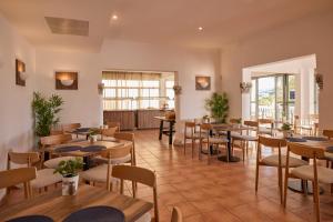 a restaurant with tables and chairs in a room at Hotel Navia Santa Ponsa - Adults Only in Santa Ponsa