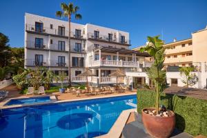 a hotel with a swimming pool in front of a building at Hotel Navia Santa Ponsa - Adults Only in Santa Ponsa