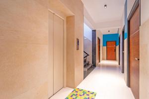 a hallway of a house with a rug on the floor at Treebo Premium Corner Stay in Coimbatore