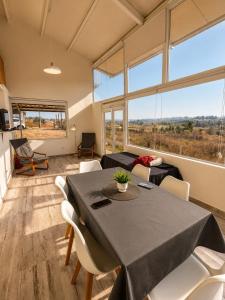 a dining room with a table and chairs and a couch at Alta Vista in Villa Yacanto