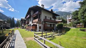 a building with a fence in front of it at Le Perce Neige in Morgex