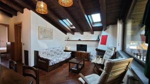 a living room with a couch and chairs at Le Perce Neige in Morgex